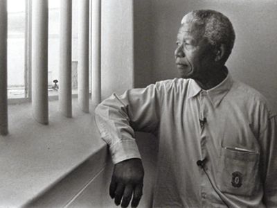 Nelson Mandela in prison looking out window