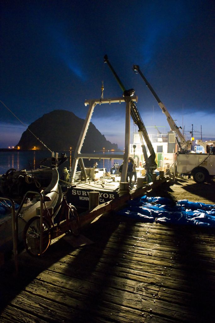 Morro Bay, California on the 4th of July. Men at work late at night