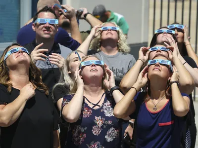 Texas Motor Speedway staff watch the August 21, 2017, total solar eclipse through special eclipse glasses.