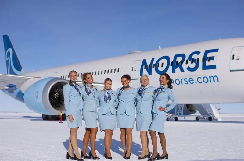 Flight attendants in front of large plane