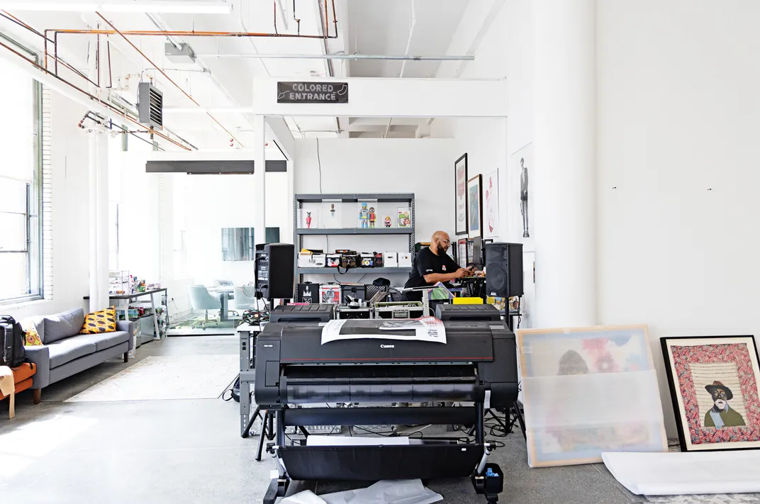 a bright room with white walls where an artist works