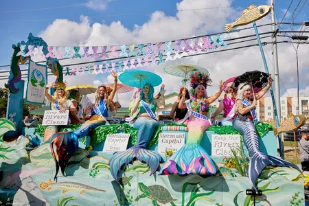 "AquaReinas," or costumed mermaid messengers with the Mermaid Society of Texas, participate in the 2022 Mermaid Capital of Texas Fest parade in San Marcos, Texas.