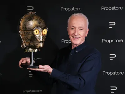 Actor Anthony Daniels holds up the helmet he wore on the set of 1983&#39;s Return of the Jedi.