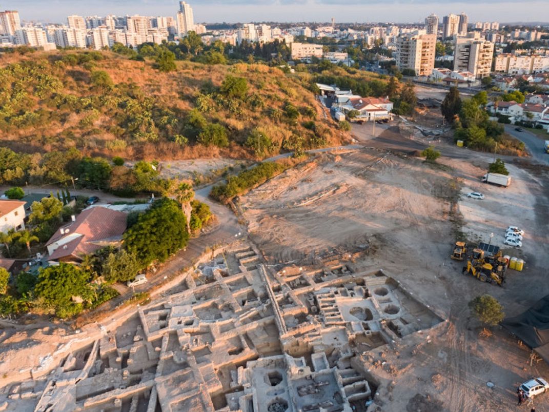 Excavation site of the winemaking operation, seen from above with buildings in the background