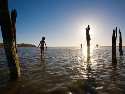 Teens from the Njarainjari Aboriginal Community walk in the shallows of Lake Albert in Southern Australia