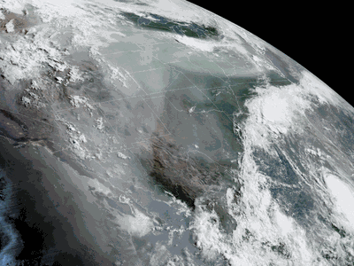 A satellite image of North America taken on August 25, 2020. Smoke from wildfires can be seen rising from California and Hurricane Laura can be seen heading toward Louisiana and eastern Texas as the remnants of Marco swirl over the Southeast.