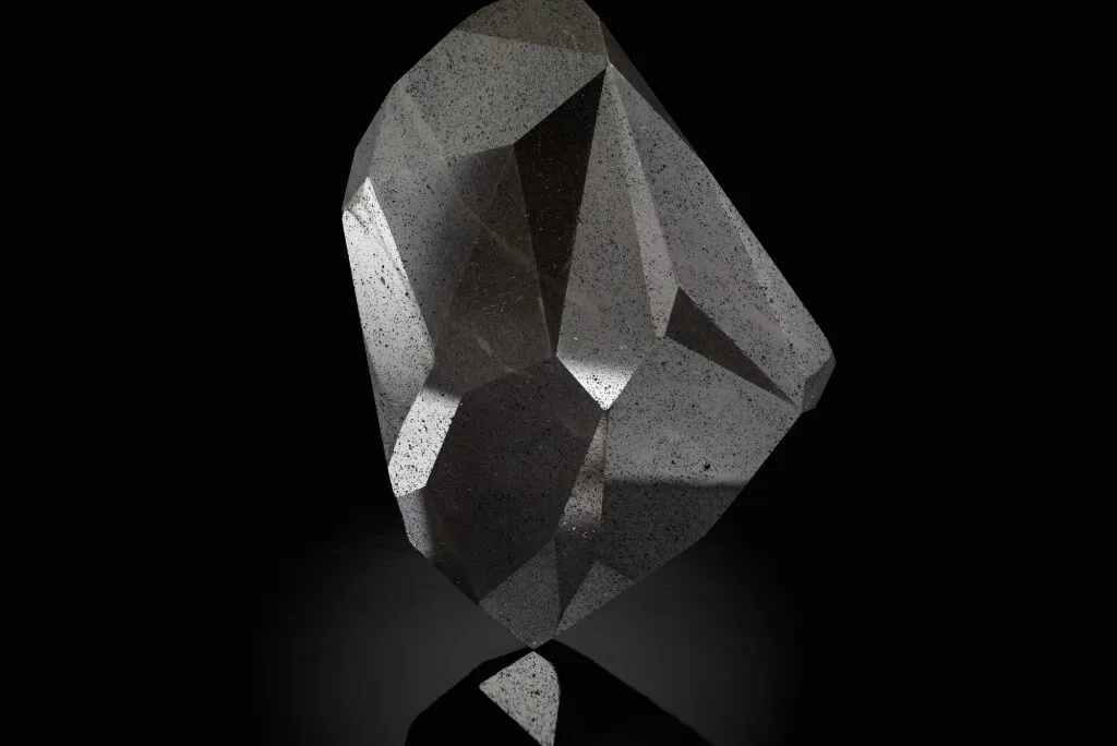 A large black gemstone with 55-facets