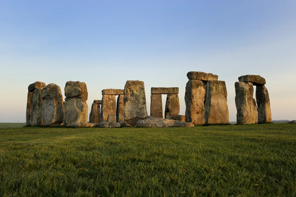 stacks of stone slabs on a green field