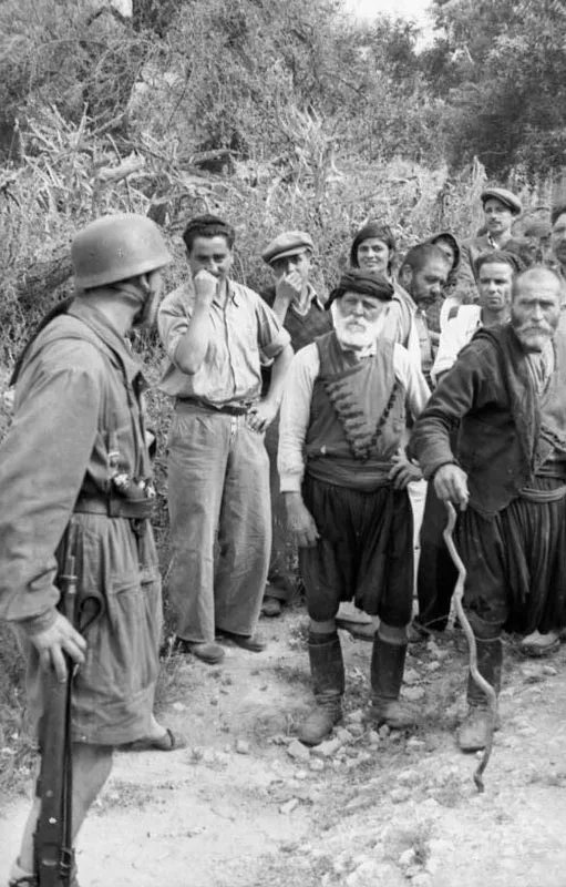 Cretan Greek civilians confronting German paratroopers before a massacre in Kondomari in June 1941
