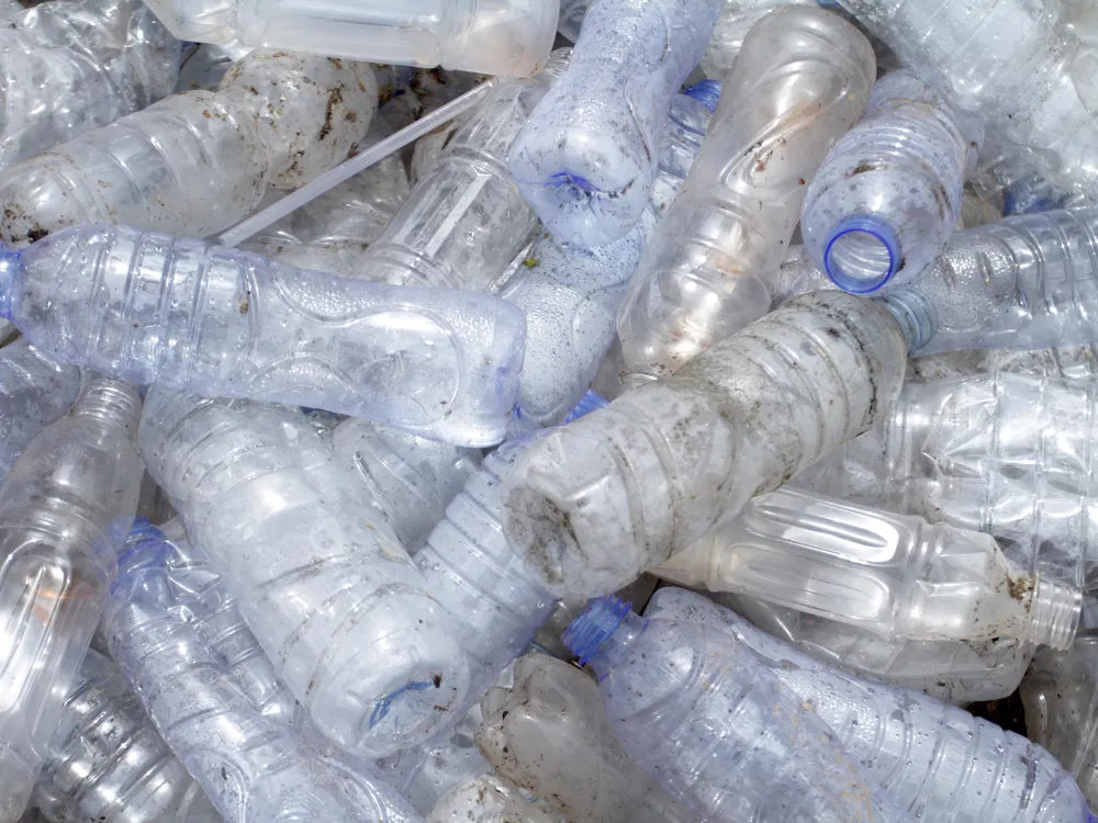 A pile of empty plastic, unlabeled water bottles