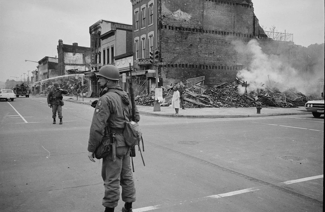 soldier standing in front of destroyed building