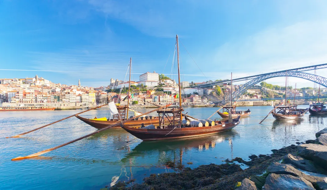 Boats moored Douro River near Porto's Dom Luis I bridge