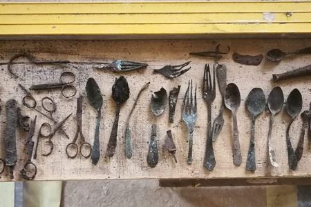 Found in Block 17, the cache includes scissors, shoemaker's tools and utensils.