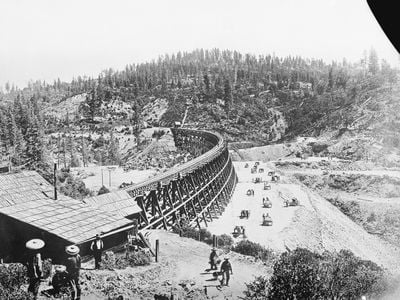 Chinese laborers at work with pick and shovel wheelbarrows and one horse dump carts filling in under the long secret town trestle which was originally built in 1865 on the Present Souther Pacific Railroad lines of Sacramento. 