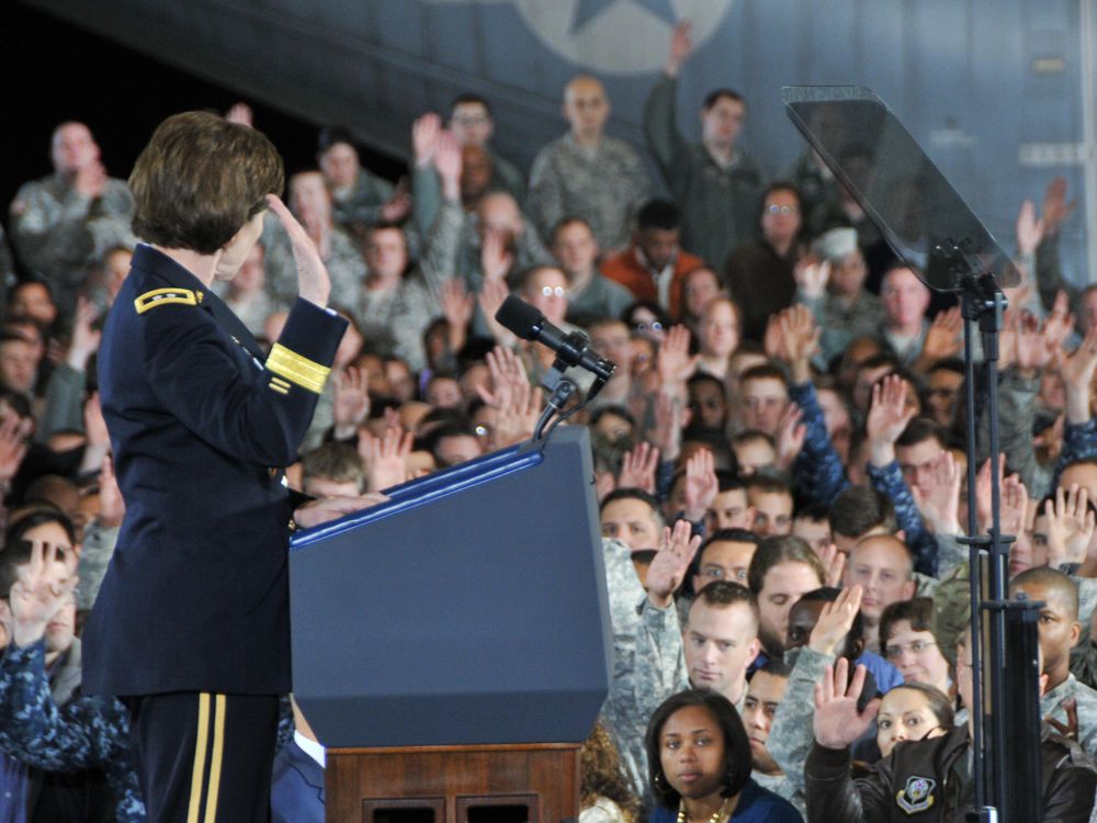 Army Reserve members raise hands