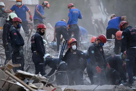 Search and rescue teams search for survivors in the debris of fallen buildings in Izmir, Turkey. 