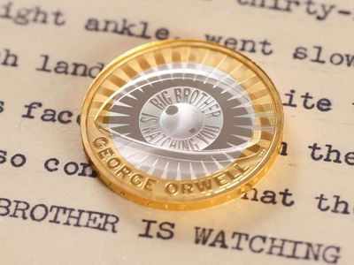 The eye on the coin does not have lashes and is designed to resemble a camera lens.