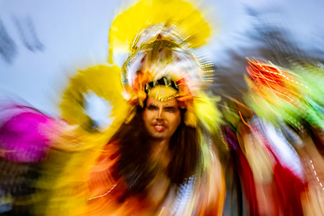 a blurred image of a dancer in a colorful costume