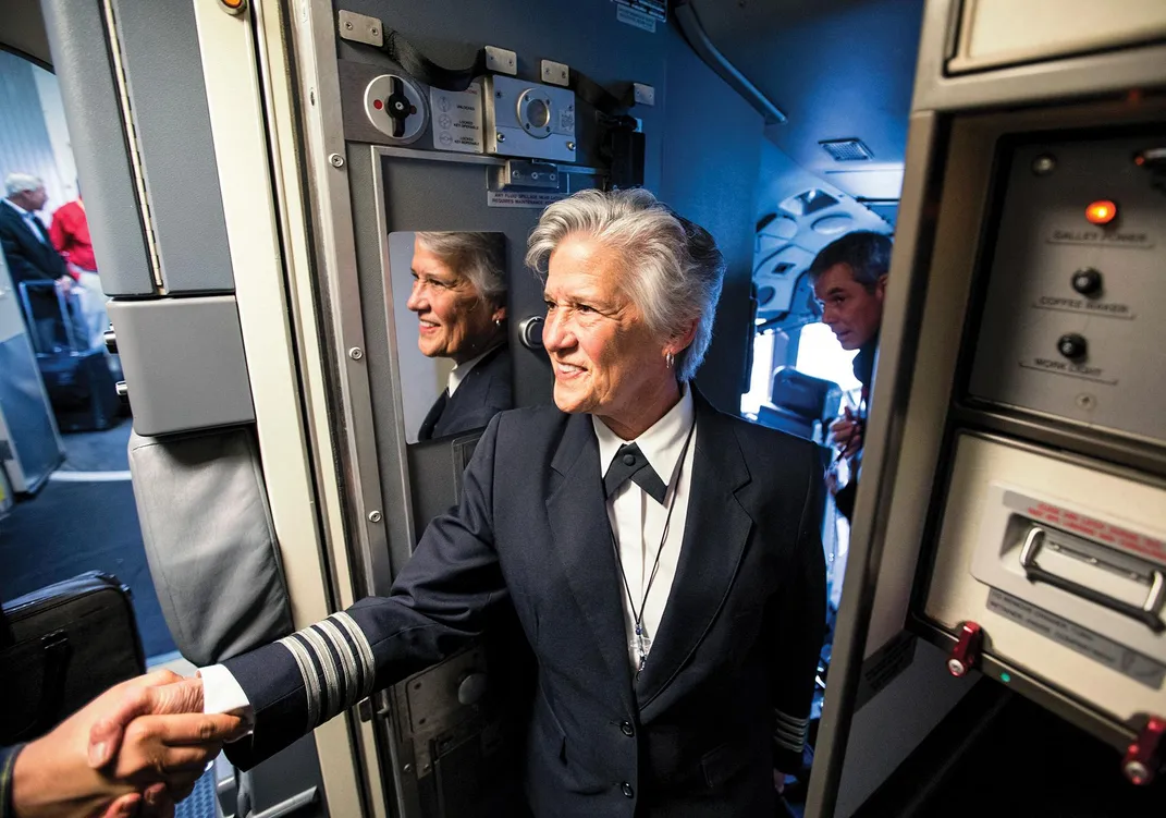 Captain Debby Rihn-Harvey exits the cockpit