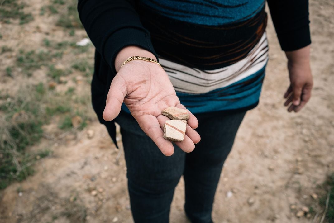 Salih holds an ancient clay fragment found in a tunnel dug by ISIS fighters under a church in the Christian town of Qaraqosh.