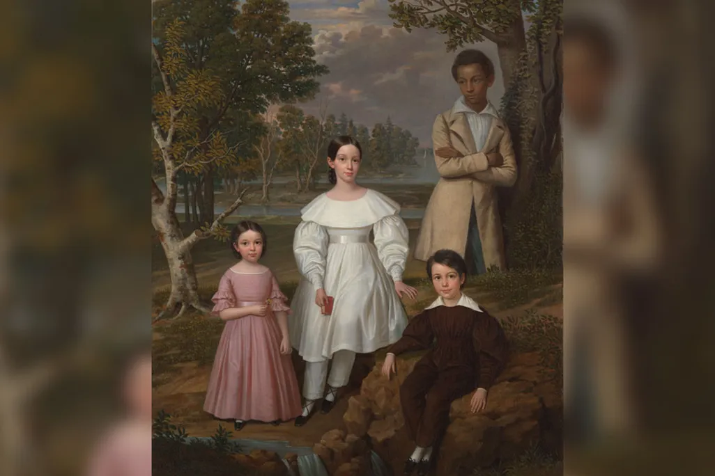 Portrait of three white children with Black teenager standing behind