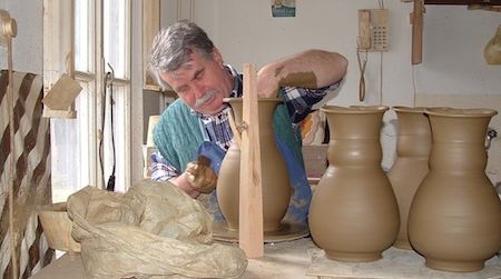A professional potter works on his craft in Mezőtúr, Hungary, a town known for its traditional pottery-making.