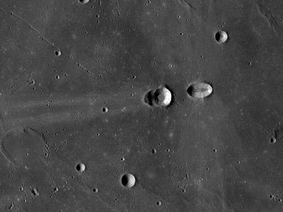 The Lunar Reconnaissance Orbiter captured this view of the craters Messier (right) and Messier A (left). Both craters were likely produced during an oblique impact, only a few degrees above the horizontal. The projectile was traveling from right to left. Messier (at right) was made first, but ricochet and downrange propagation of the top of the projectile (decapitation) made Messier A. Note the ejecta blanket of Messier extend at right angles to the impact direction, while whisker-like rays extend downrange from Messier A in the same direction as the impact.