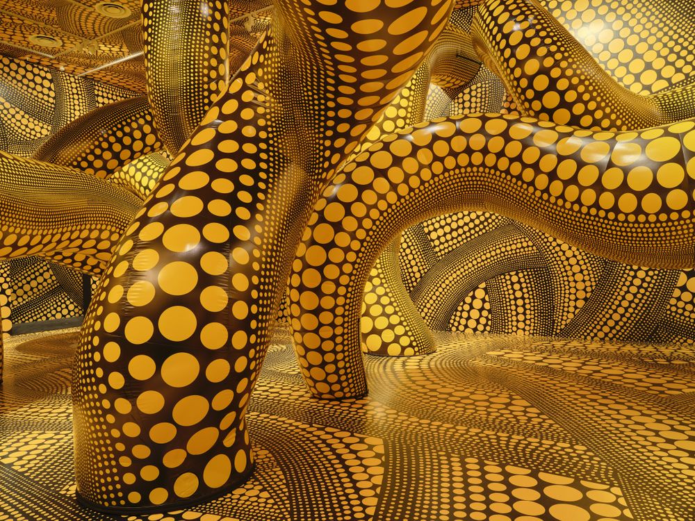 Worm-shaped figures covered in yellow polka dots