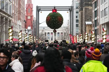 The crowd stood beneath a large mistletoe installation for the world record attempt on December 13.