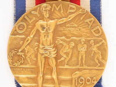 The gold medal still has its original ribbon and leather case.