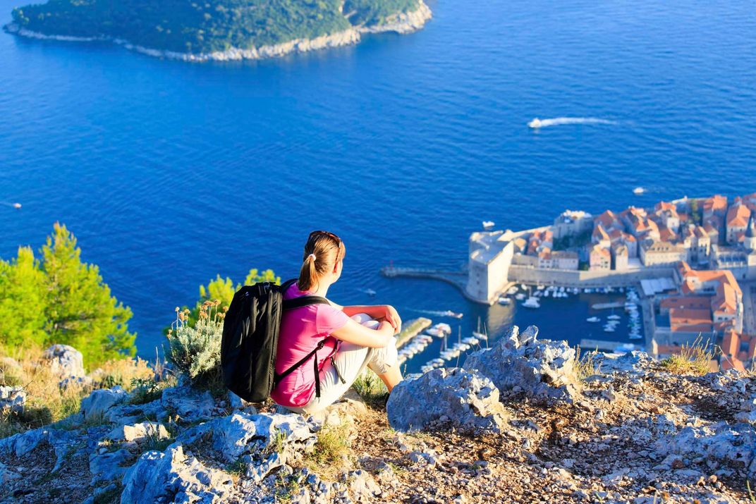 Hiker taking in panoramic view of Dubrovnik
