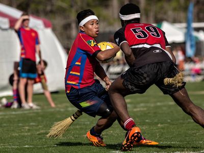 Players from the University of Sydney and McGill University grapple over the quaffle during the 2014 Quidditch World Cup in Myrtle Beach, South Carolina