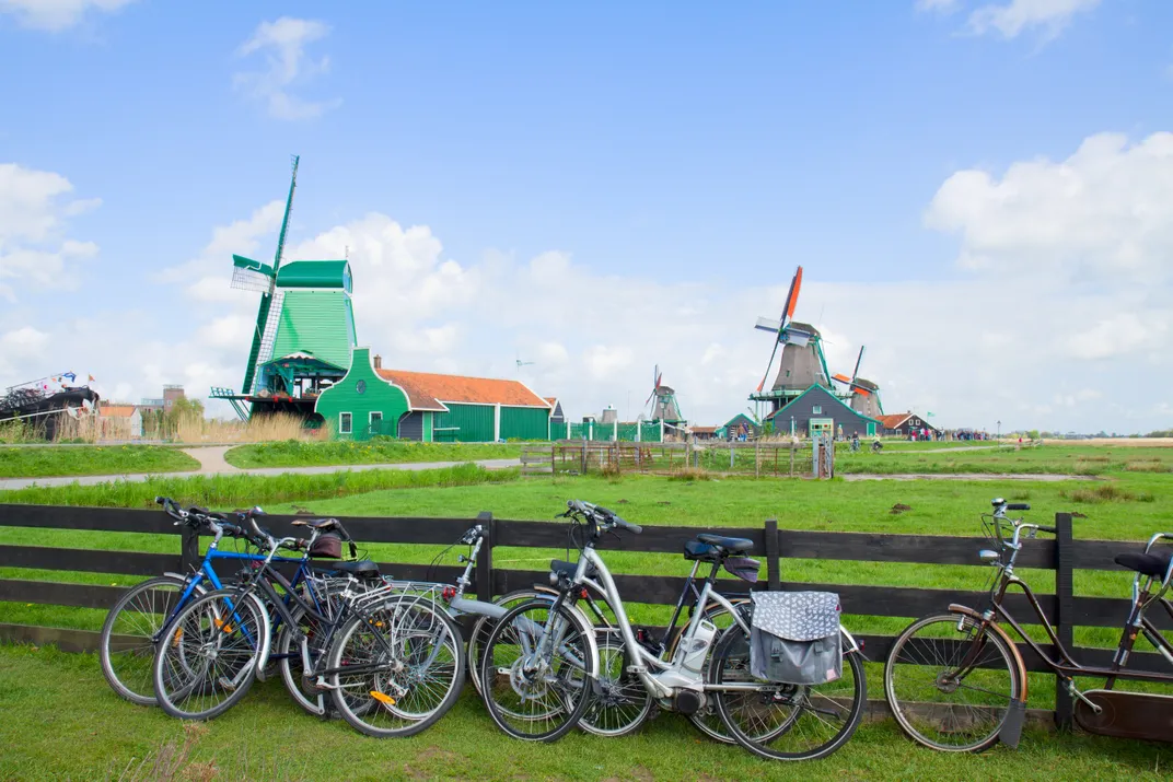 Traditional Dutch landscape of countryside, windmills, and bicycles