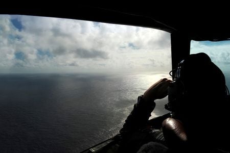 A Royal New Zealand Air Force P-3 searches the Indian Ocean off the coast of Western Australia for debris after the Malaysian airliner vanished.