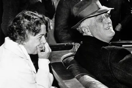 Eleanor Roosevelt leans forward from the back seat of the Roosevelt car to catch a comment from her husband, Franklin, as they campaign for his fourth term as president. 