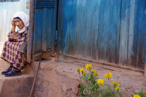 Old woman and yellow flowers thumbnail