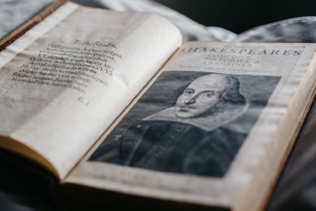 Open book with illustration of Shakespeare on the right-hand page