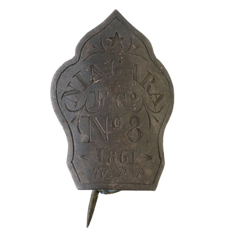 Small metal badge, decorated with an engraved star and other small line flourishes. The main engraving reads "Niagra, F. C., No. 8, 1861, W. P. P."