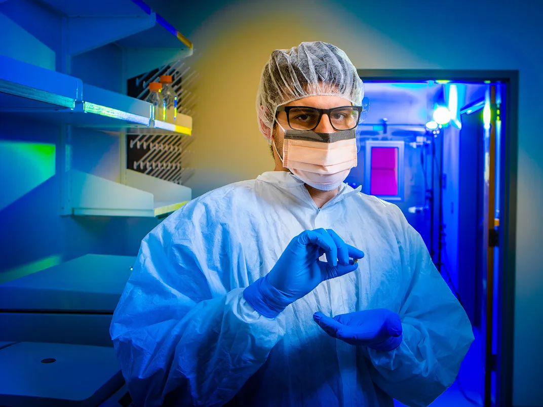 Scientist Holds a Bone Fragment