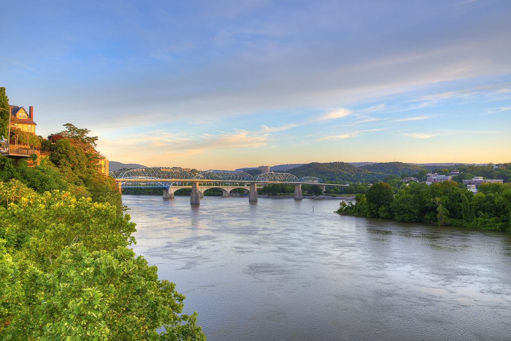 River with bridge over it and trees on the banks