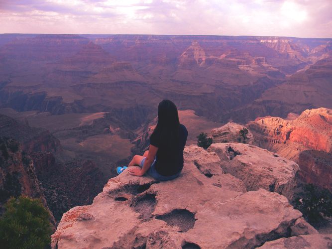 My sister sitting on the edge of the Grand Canyon watching the sunset ...