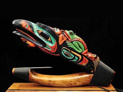 Tlingit artist Arthur B. Nelson’s Devil Fish Halibut Hook, 2012, is an impressive example of a contemporary wooden halibut hook designed to be a piece of art rather than a functional example of halibut fishing equipment. The carving depicts raven, frog, octopus, and human spirits. 