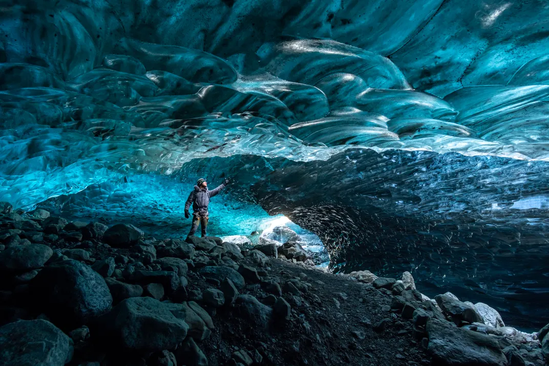 9 - Iceland’s ice-draped caves, created when water from the glacier melts parts of it away, change color depending on how the sunlight hits them.