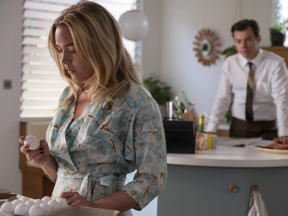 Florence Pugh (left) stars in Don't Worry Darling as Alice, a 1950s housewife who resides in an idyllic California community with her husband, Jack (Harry Styles, right).