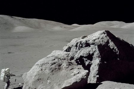 Jack Schmitt picking up the gnomon after collecting samples. This view is to the west toward the Lee Lincoln Scarp. Apollo image AS17-140-21496.