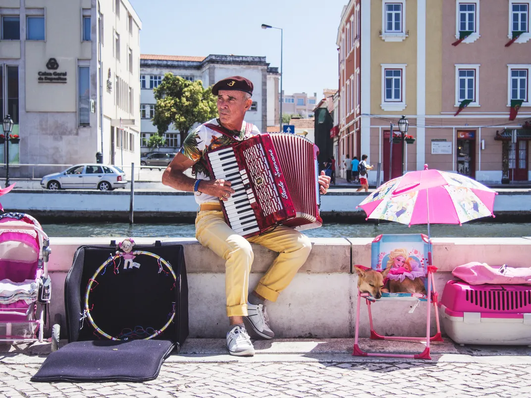 A color-clad musician entertains passers-by.