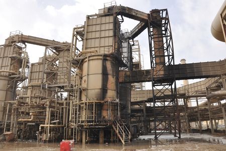 A view of a damaged production unit after a bomb attack at Baiji oil refinery, 180 km (112 miles) north of Baghdad February 26, 2011. Militants attacked Iraq's largest oil refinery on Saturday, killing four workers and detonating bombs that touched off a raging fire and shut down the plant in northern Iraq, officials said