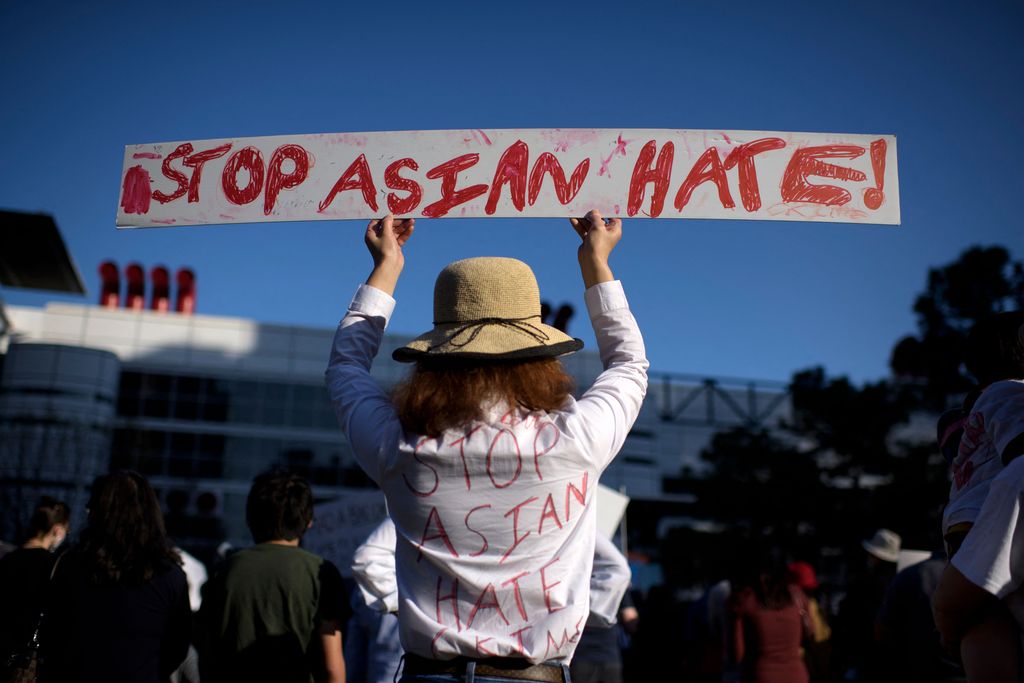 Woman holding sign that says Stop Asian Hate