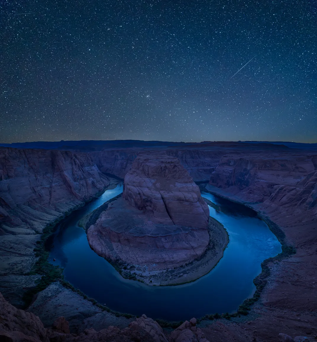 Ein sternenklarer Nachthimmel reflektiert das Licht im seichten Wasser von Horseshoe Bend im Glen Canyon National Recreation Area