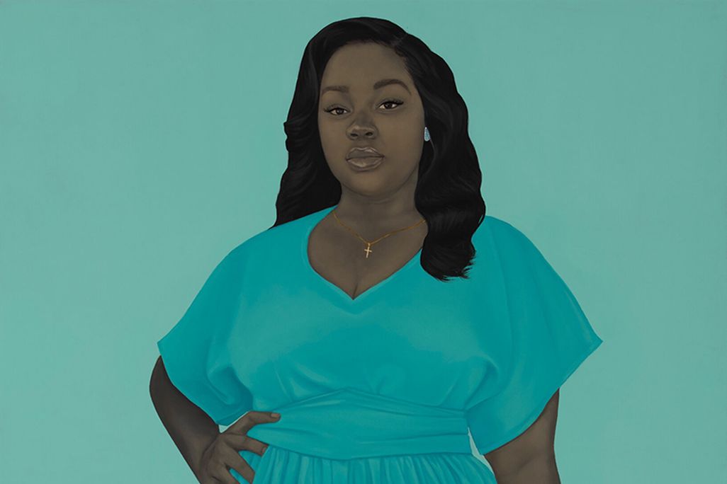 A portrait of Breonna, a young Black woman, stands in front of a light turquoise background and wears a flowy blue gown, with a ring on her figer, her hair curled and long and her right hand resting on her hip